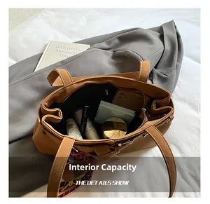 Spacious interior of brown PU leather tote bag showing storage for phone and cosmetics