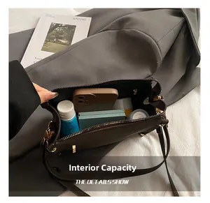 Interior view of the dark brown Boston bag showing capacity for phone and cosmetics