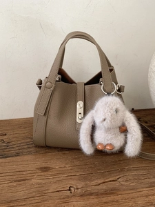 Litchi pattern leather bucket bag in earthy brown with silver lock and rabbit charm