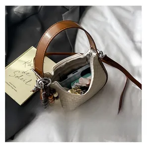Top view of cream woven handbag showing spacious interior with personal essentials