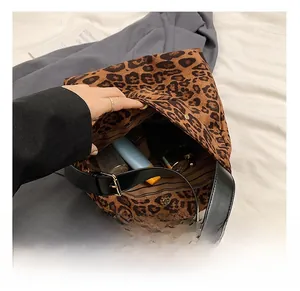 Detail view of large leopard print bucket bag interior showing spacious striped lining