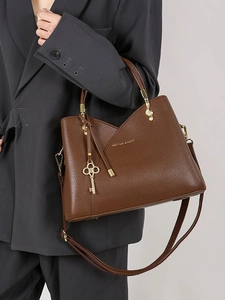 Vintage dark brown pebble leather handbag with gold hardware and adjustable strap