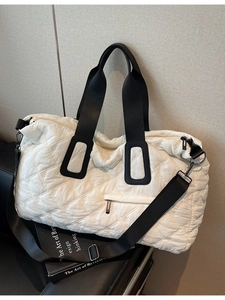 Large white quilted fitness bag with black straps for travel and sports use