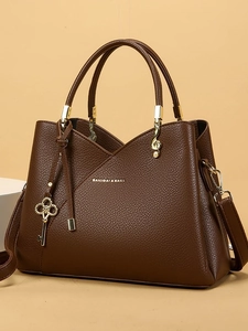 Retro dark brown pebbled leather bucket bag with gold charms and top handles