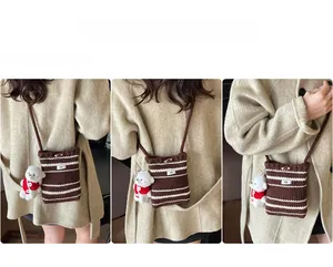 Knitted crossbody bag featuring brown stripes and a cute bear plush toy accessory