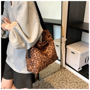 Close-up of leopard print tote bag with a wide black shoulder strap for daily commuting