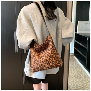 Detail of large leopard print hobo bag showing the pattern and wide black strap