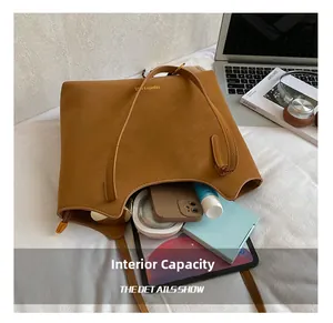 Internal capacity of brown leather tote showing space for tablet and essentials