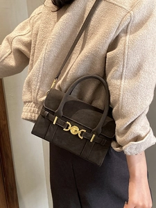 Deep brown matte square shoulder bag with gold clasp shown on model