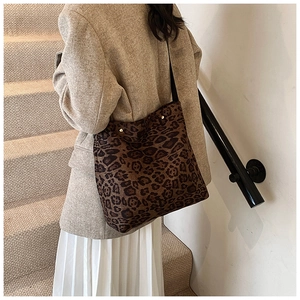 Detailed side view of large leopard print tote bag worn on shoulder for daily commute