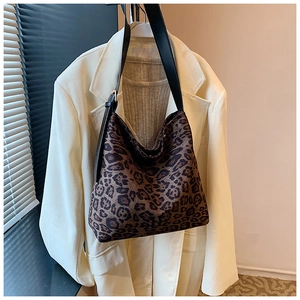 Detail of adjustable black leather strap and leopard print fabric on large tote bag