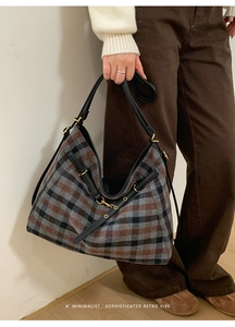 Detail of retro plaid tote bag showing thick woolen texture and black leather strap
