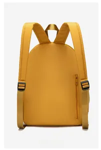 Detail of mustard yellow backpack featuring padded shoulder straps and side zipper pocket