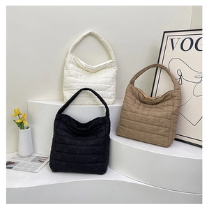 Three quilted puffer dumpling bags in white, black, and khaki showing texture and colors