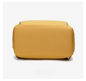 Detail view of mustard yellow backpack bottom with reinforced oxford fabric stitching
