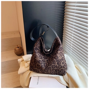 Detailed view of the leopard print hobo bag with wide strap and metallic buckles