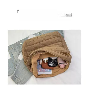 Top view of spacious interior of quilted tote bag with tablet and daily essentials
