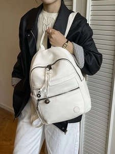 White lychee leather backpack for commuting featuring drawstring and bell detail