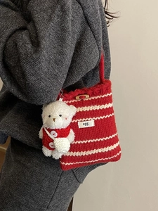 Knitted bucket bag with red and white stripes and a cute plush bear pendant