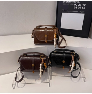 Three vintage boston bags in brown, dark coffee, and black with beaded tassels