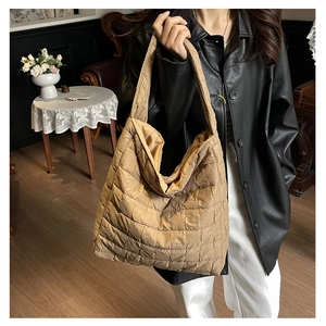 Close-up of quilted fabric texture and stitching on khaki large capacity tote bag