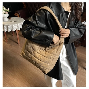 Close-up of khaki quilted texture and woven details on a large lightweight tote bag