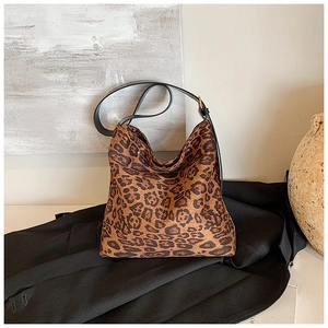 Detailed view of leopard print shoulder bag with adjustable strap and gold hardware