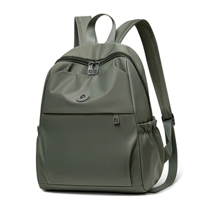 Detail view of olive green waterproof oxford cloth backpack with front zipper pocket
