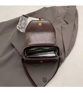 Detail of dark brown vintage textured leather handbag showing spacious interior capacity