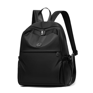 Detail of premium black nylon backpack showing smooth texture and side drawstring pocket
