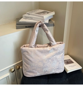 Detail of embroidered silk tote bag with classical landscape patterns and padded handle