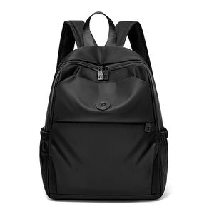 Front detail of black oxford cloth backpack showing dual zippers and side pocket