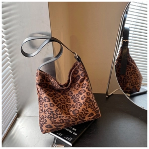 Detail of leopard print hobo bag with black leather strap and gold buckle adjustment