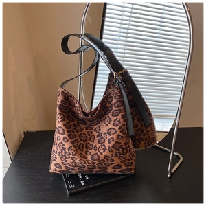 Detail of leopard print hobo bag showing faux suede texture and black leather strap