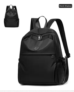 Detail view of the black Oxford cloth backpack with metal zippers and side pocket