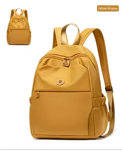 Front and side view of water-resistant yellow oxford backpack with dual zippers