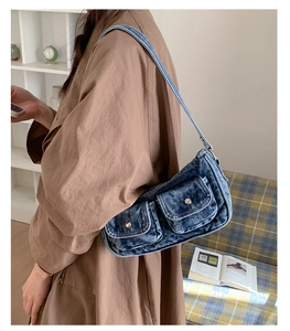 Retro washed denim shoulder bag with vintage dual flap pockets shown on model