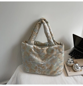 Detailed view of quilted tote bag with Chinese landscape embroidery and padded handles