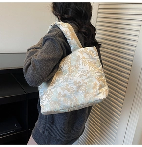 Detail of quilted tote bag with silk texture and traditional Chinese landscape patterns