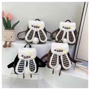 Detail view of stylish plush backpacks with cute rabbit ears and Happy Days patches