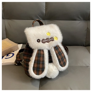 Detail of plush rabbit backpack featuring Happy Days patch and floral button decor