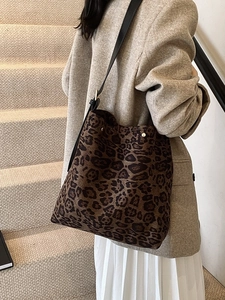 Large leopard print bucket bag with black leather strap and rivet details for women