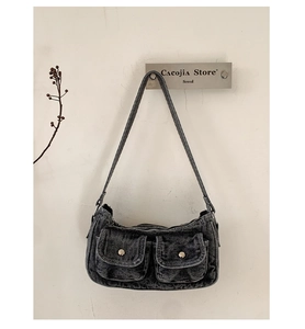 Detailed close-up of retro dark gray denim shoulder bag with vintage cargo pocket design