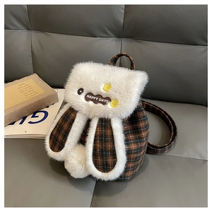 Detailed view of plush rabbit backpack with brown checkered pattern and floral accents