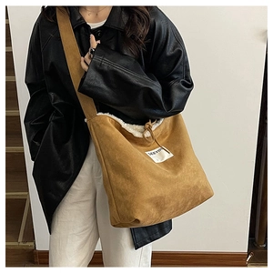 Detail of camel faux suede bucket bag with white faux fur lining and drawstring