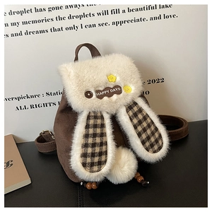 Detail of bunny plush backpack featuring brown suede texture and cute floral embroidery