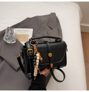 Detailed view of black oil wax texture PU leather with vintage wrinkled effect and gold lock