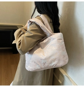 Detail of light pink Chinese embroidery quilted puffer tote bag with landscape pattern