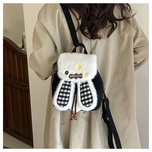 Detail of cute rabbit plush backpack with checkered ears and Happy Days patch on model