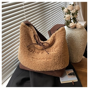 Close-up of fluffy brown lamb wool tote bag with detailed embroidery and bow tie